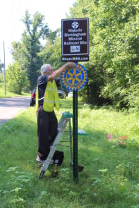 Installing Trussville Daybreak Rotary Club sponsorship sign.